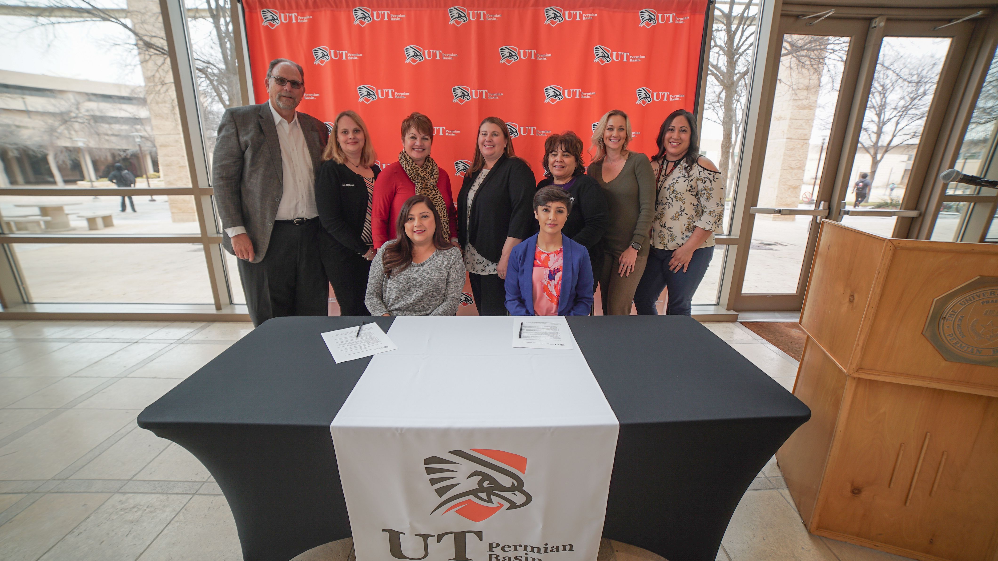 Education Foundation representatives smile with Dr. Woodley