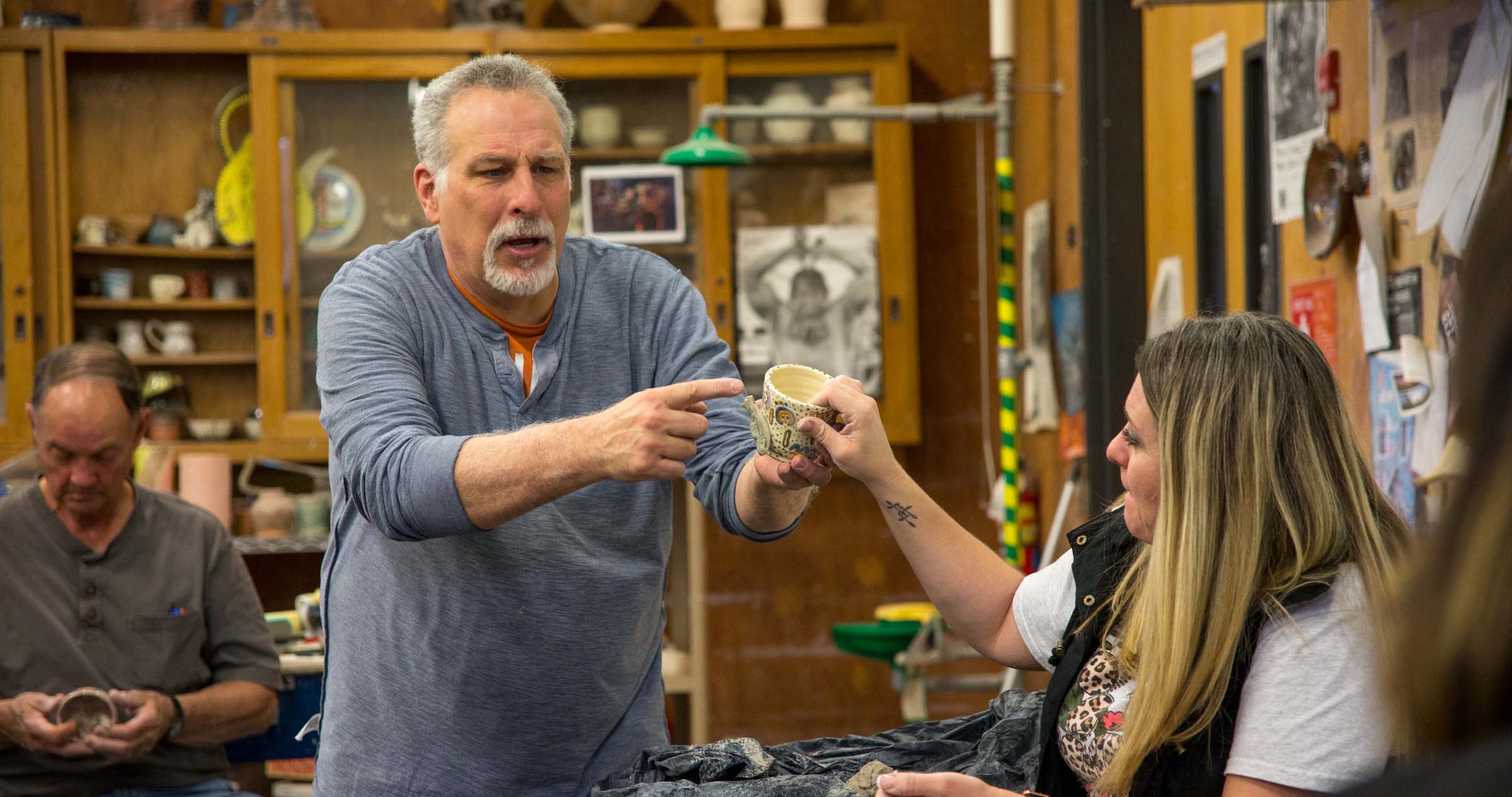 Associate Art Professor, Chris Stanley shows class a bowl