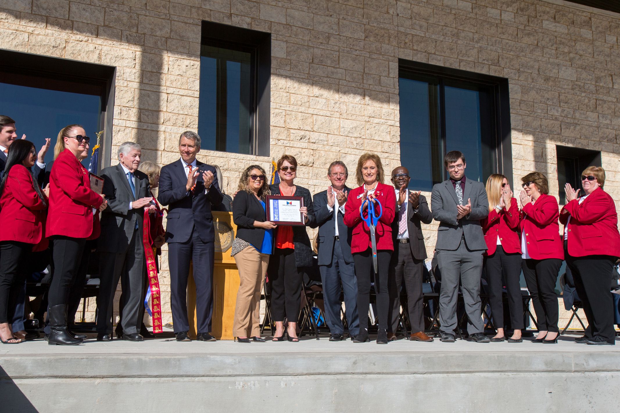 Dr. Woodley accepts plaque from Odessa Chamber of Commerce at Grand Opening Ceremony