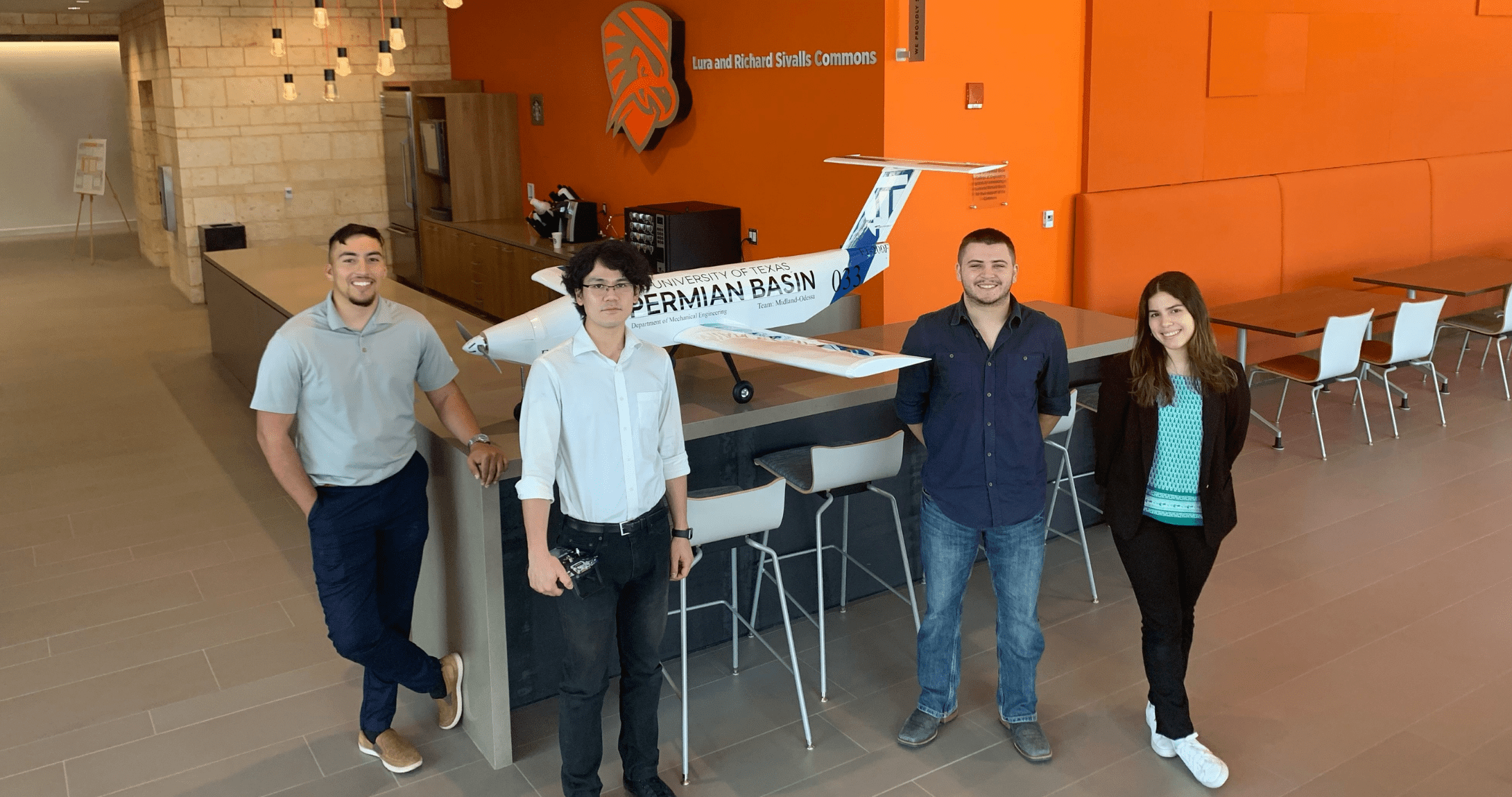 Engineering students posed with airplane they designed and built.