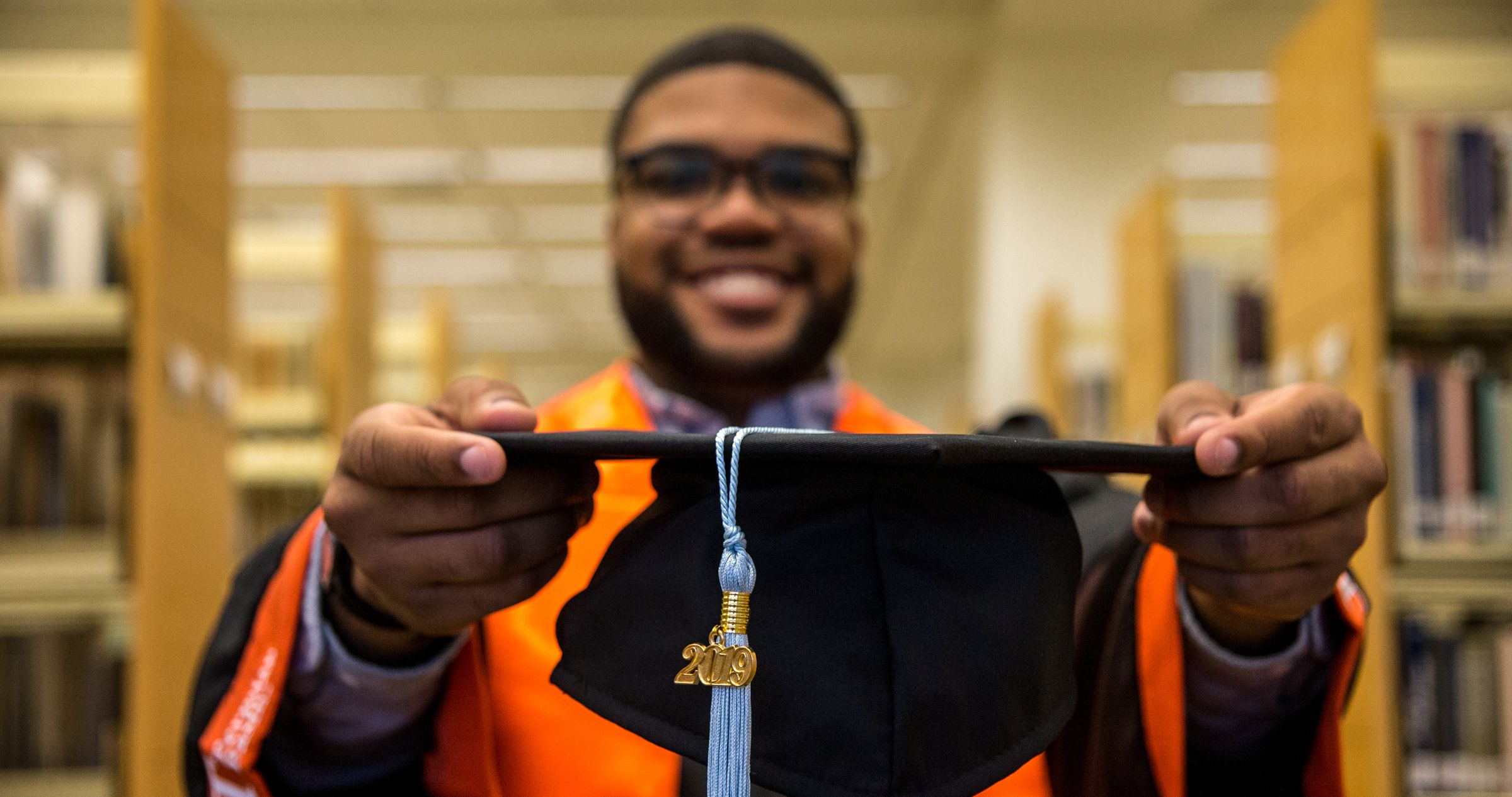 Student holds out graduation cap