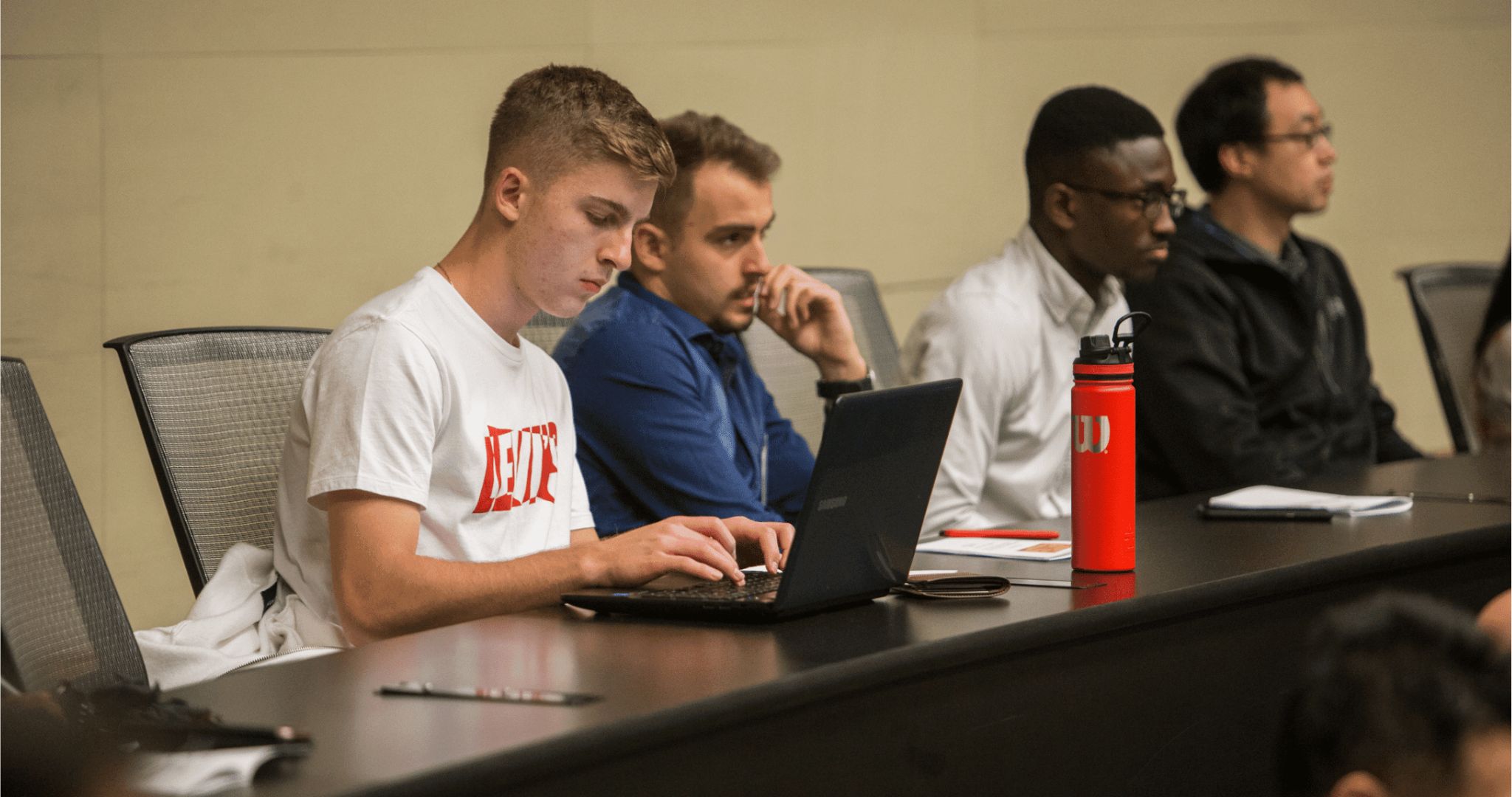 student typing on laptop