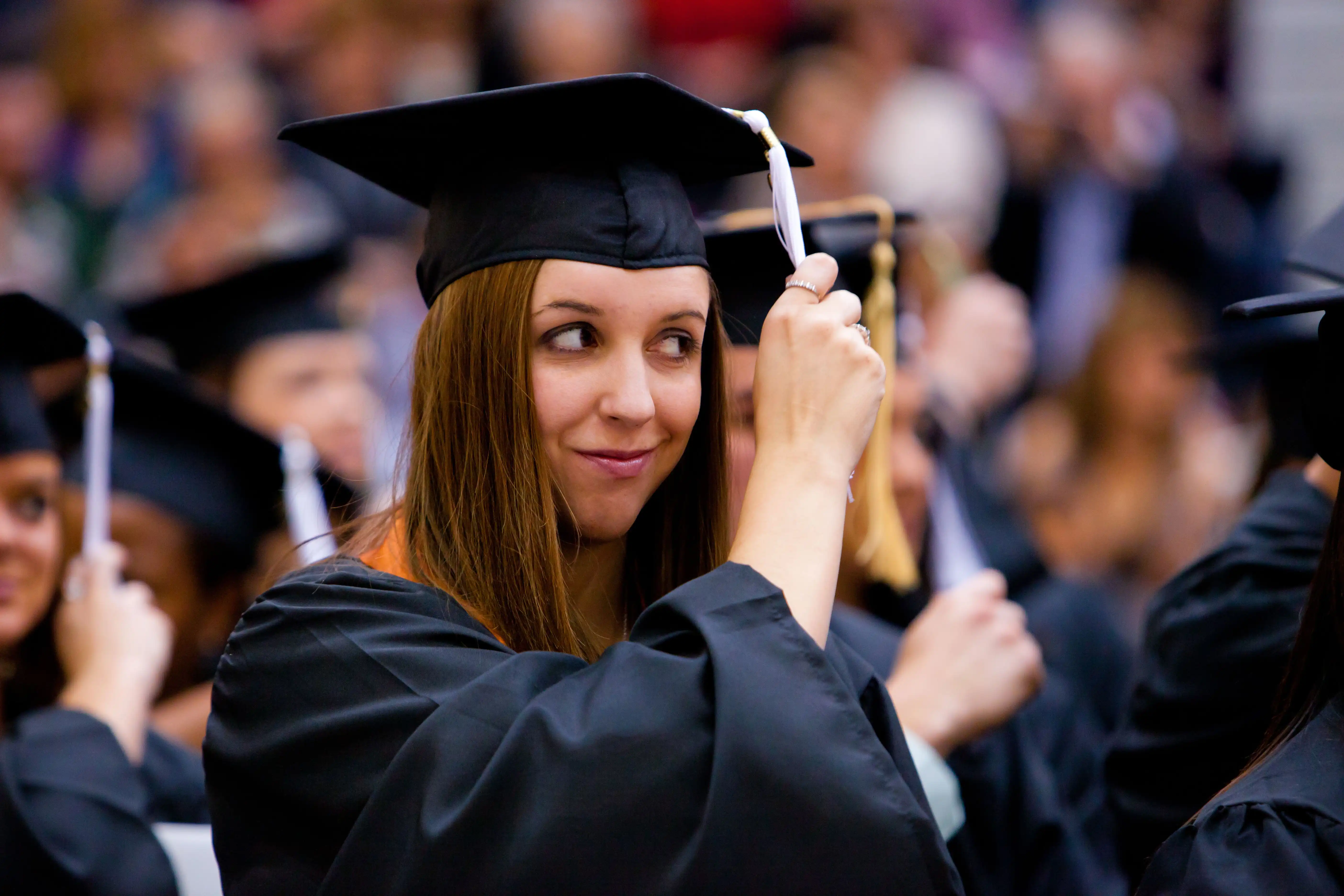 student moving tassel at graduation