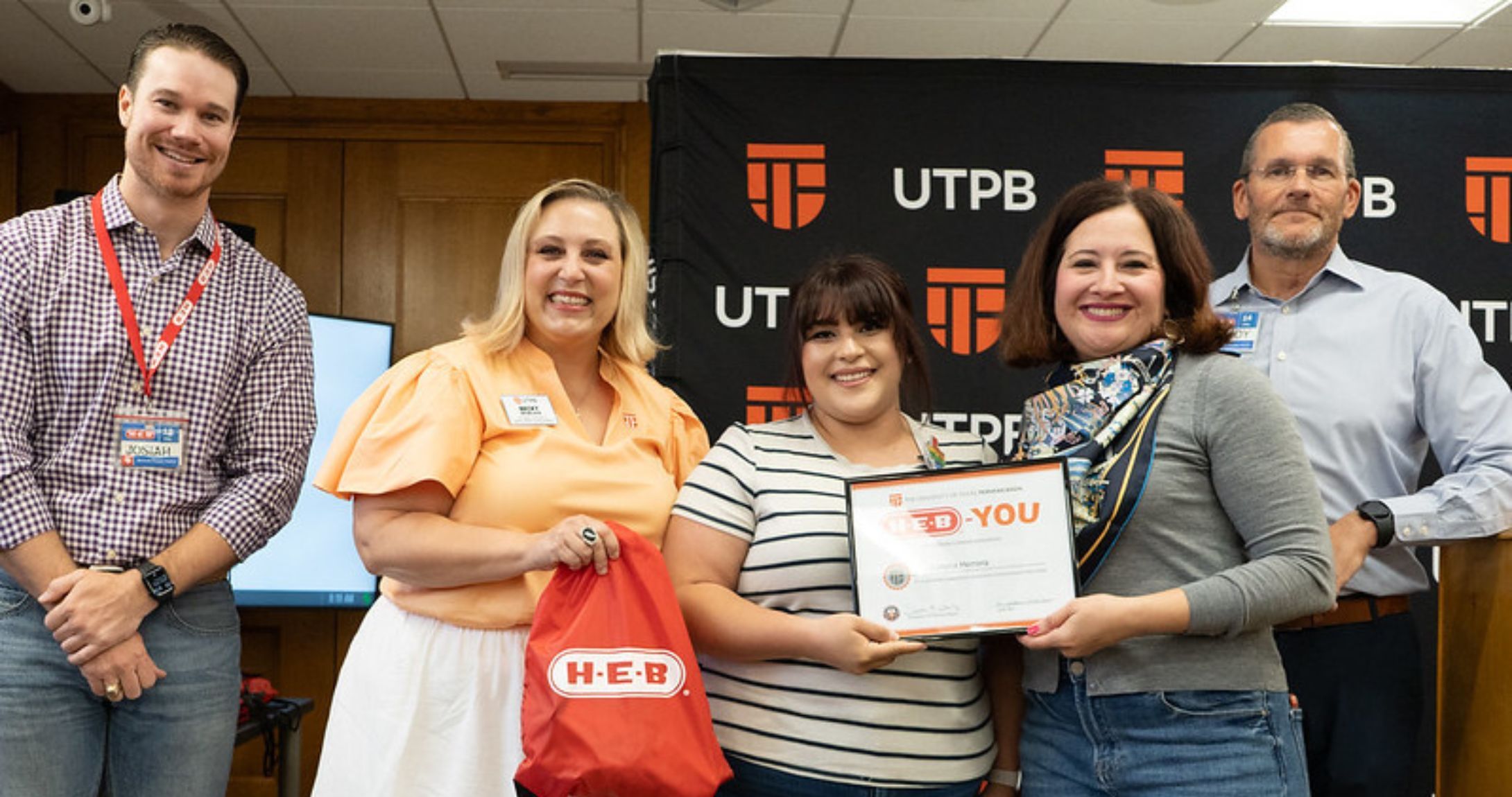 HEB You Grad smiling in group photo