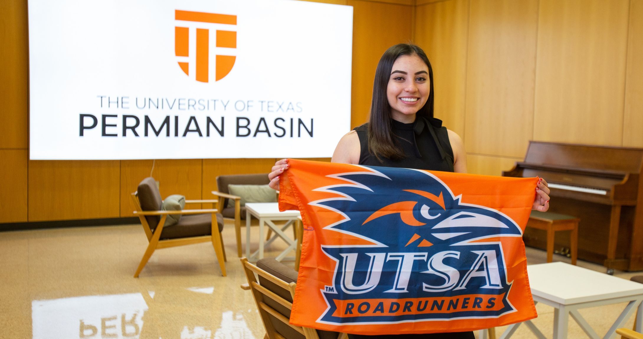 student holding UTSA flag 