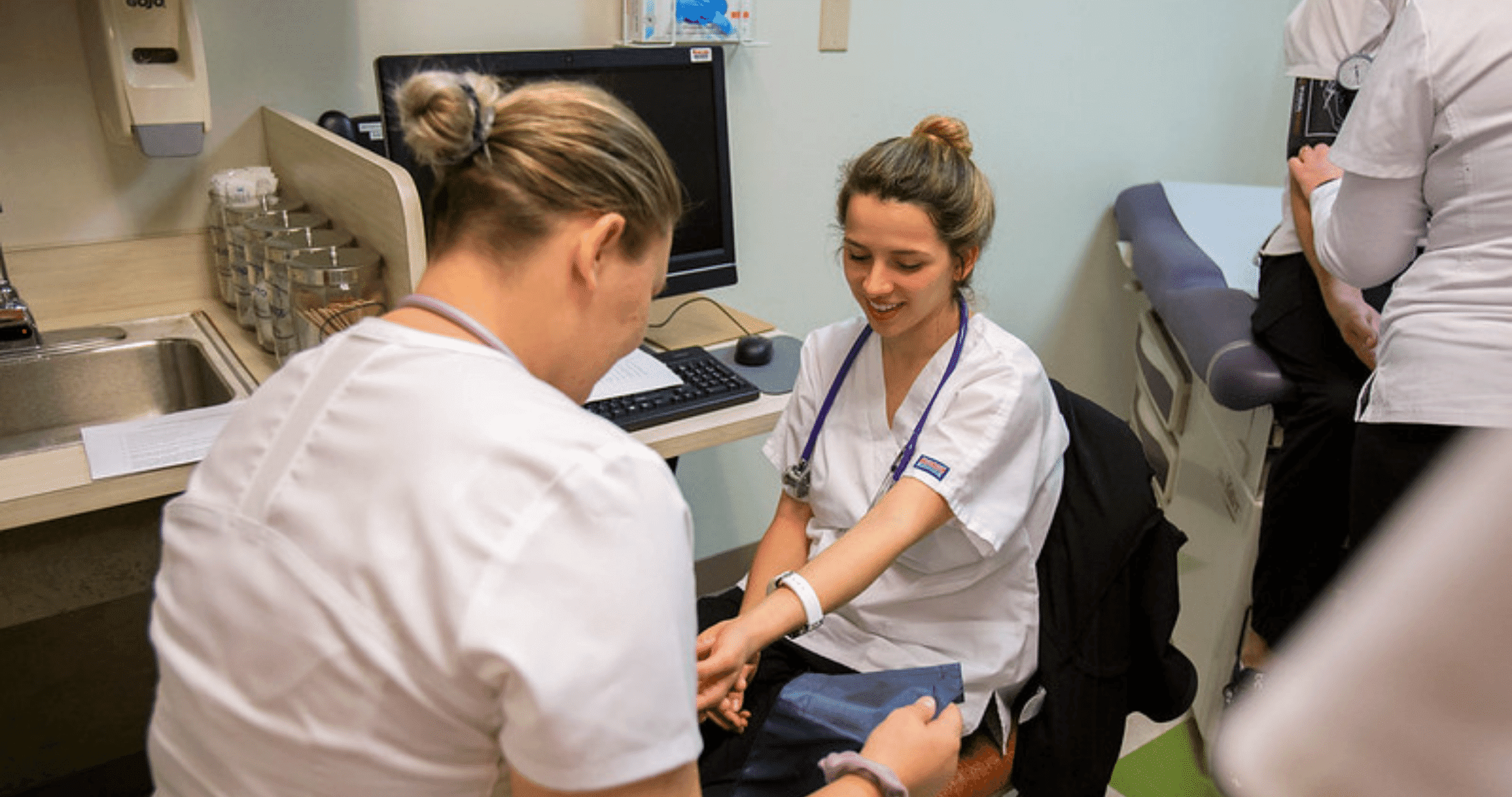 Nursing students taking blood pressure