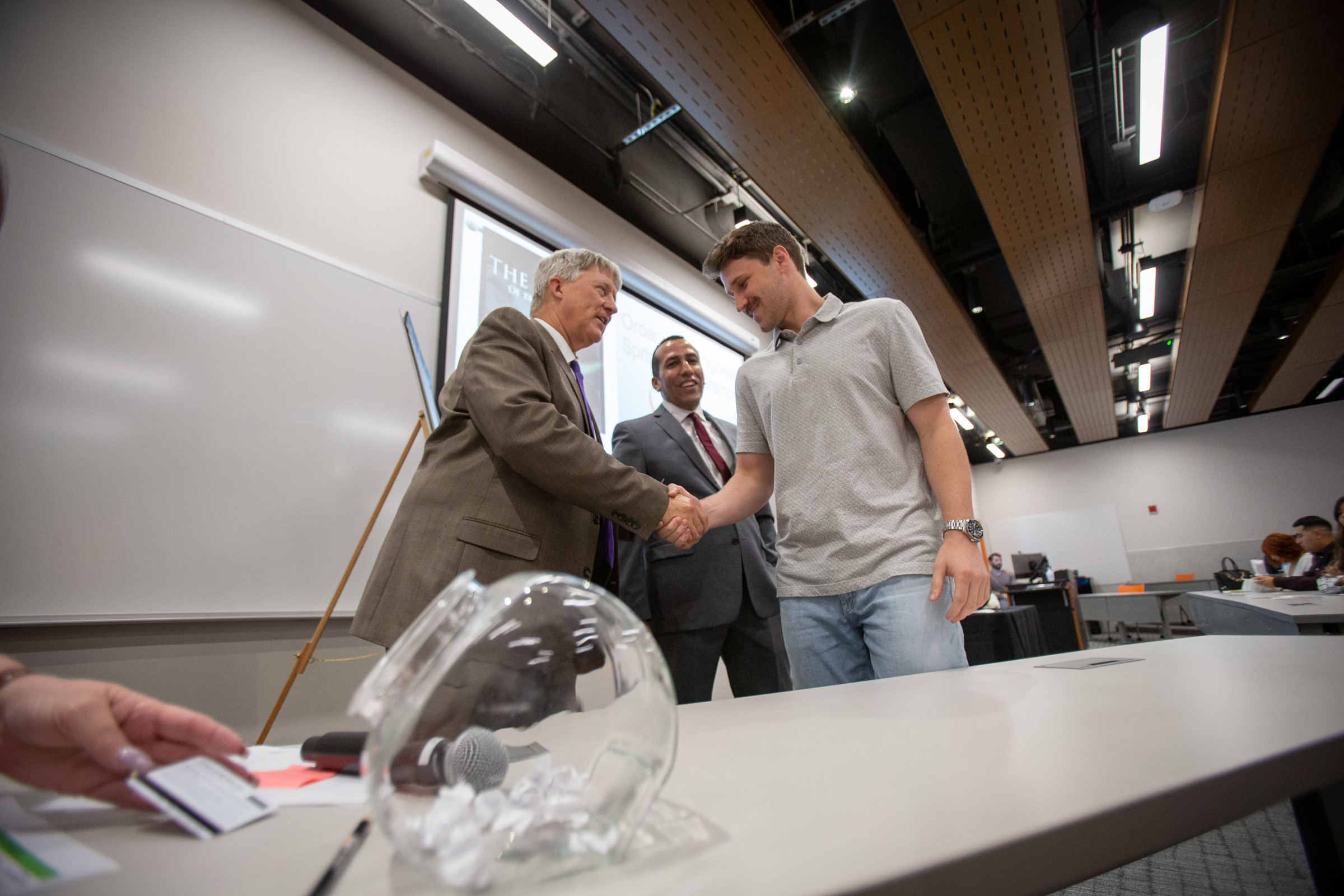 Student shaking Dr. Rencis hand at Order of the Engineer