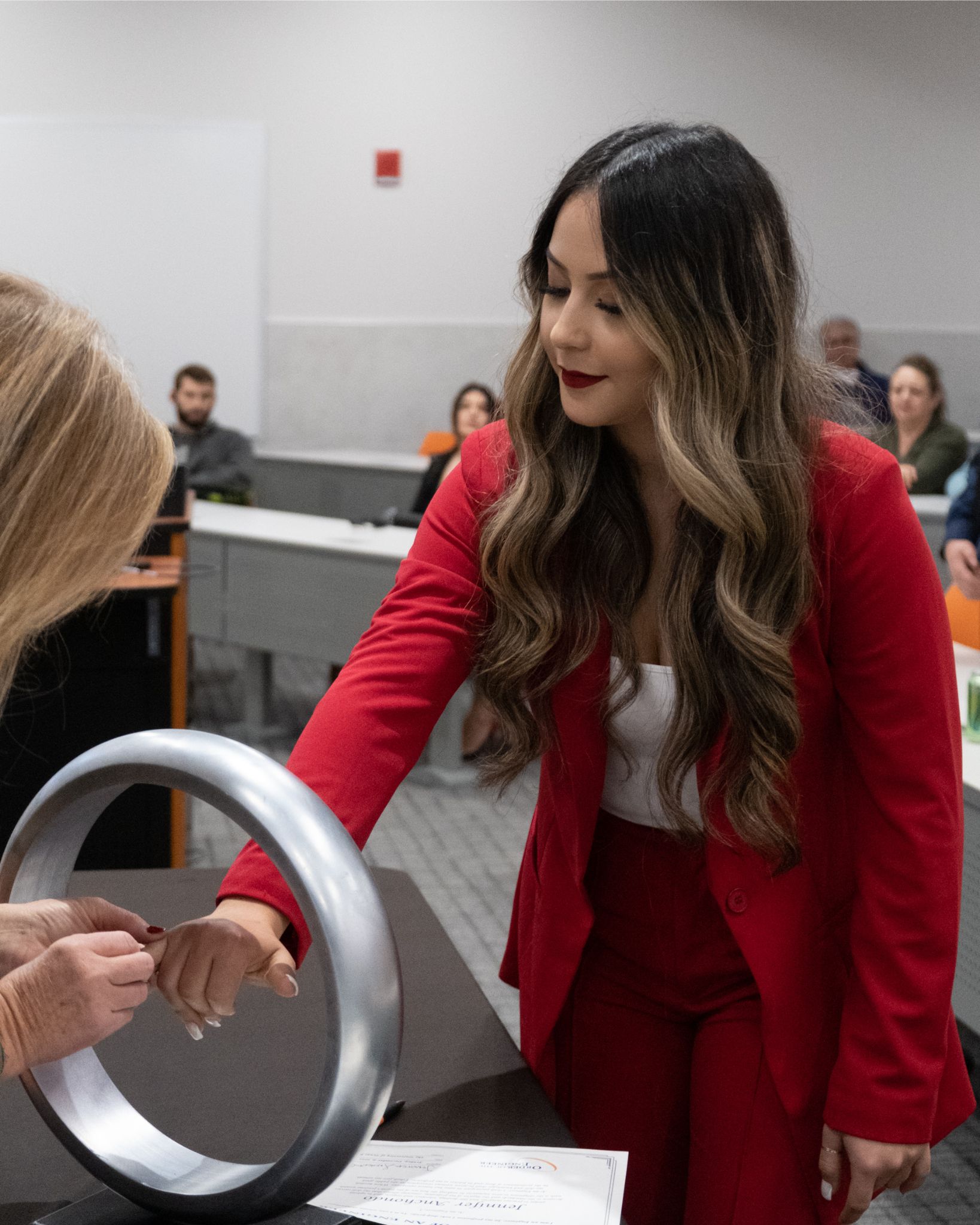 Female student receiving her ring at ceremony