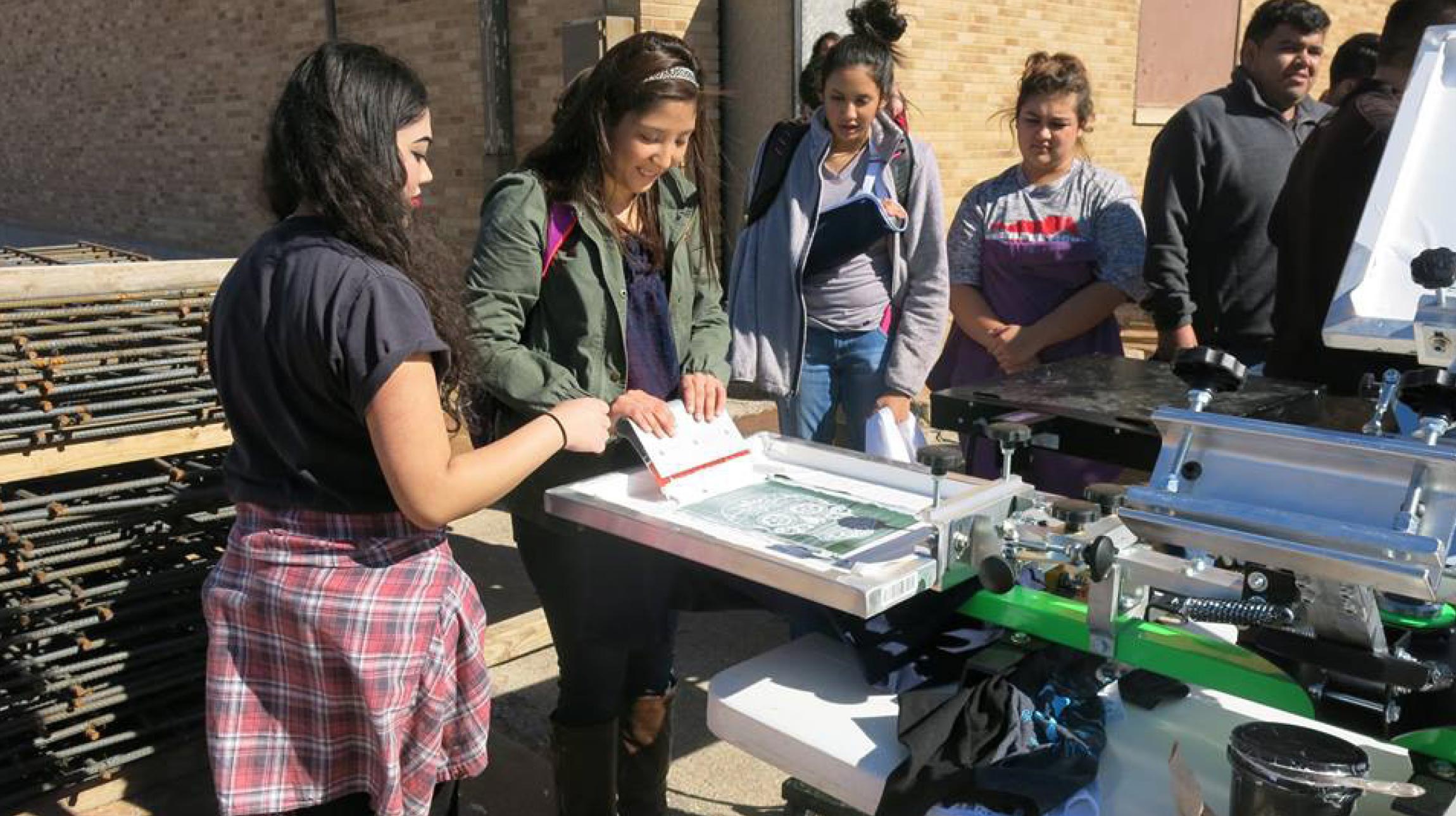 Students working with t-shirt press