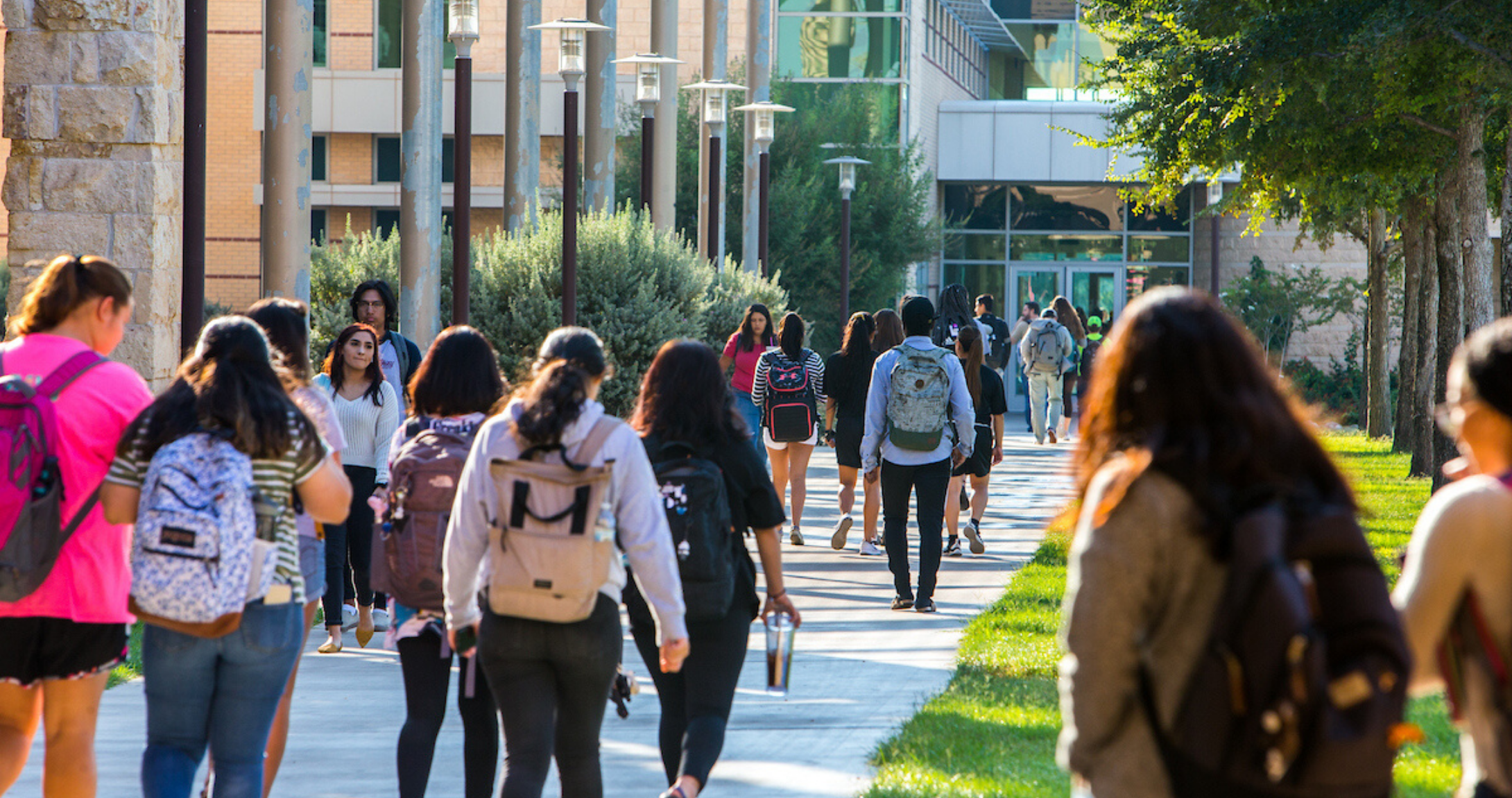Students walking on campus in courtyard