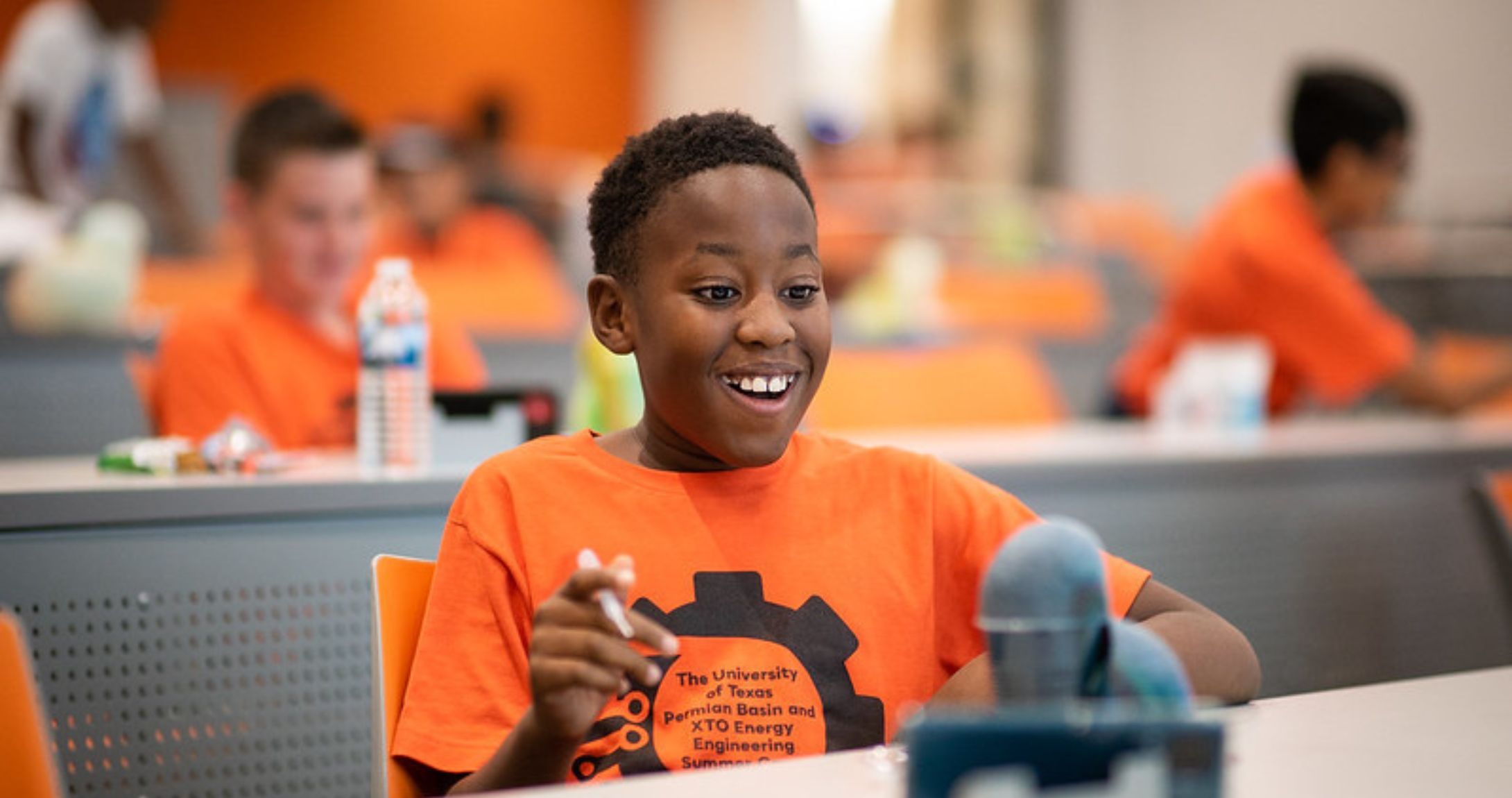 child smiling doing science experiment