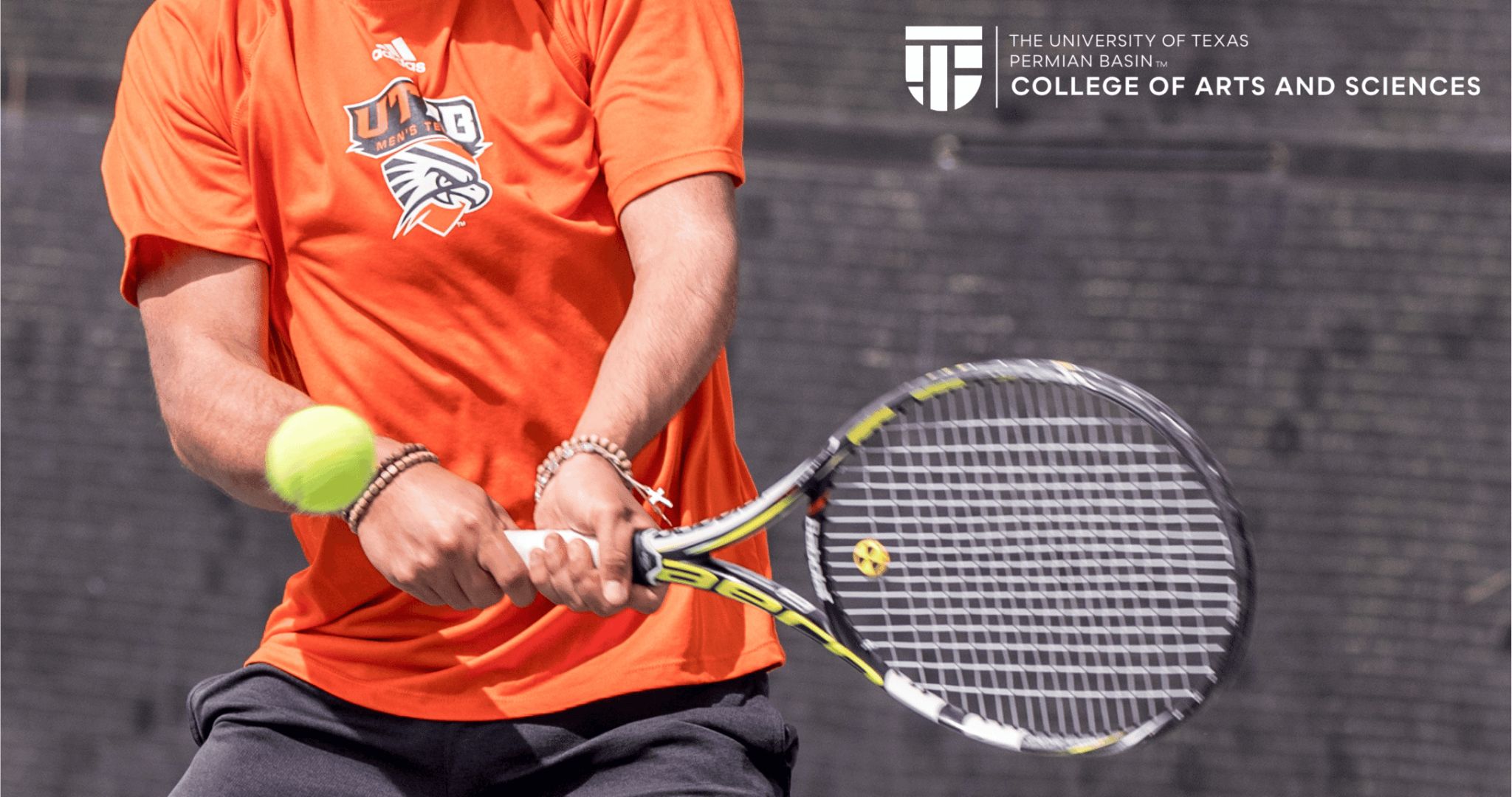 student holding tennis racket