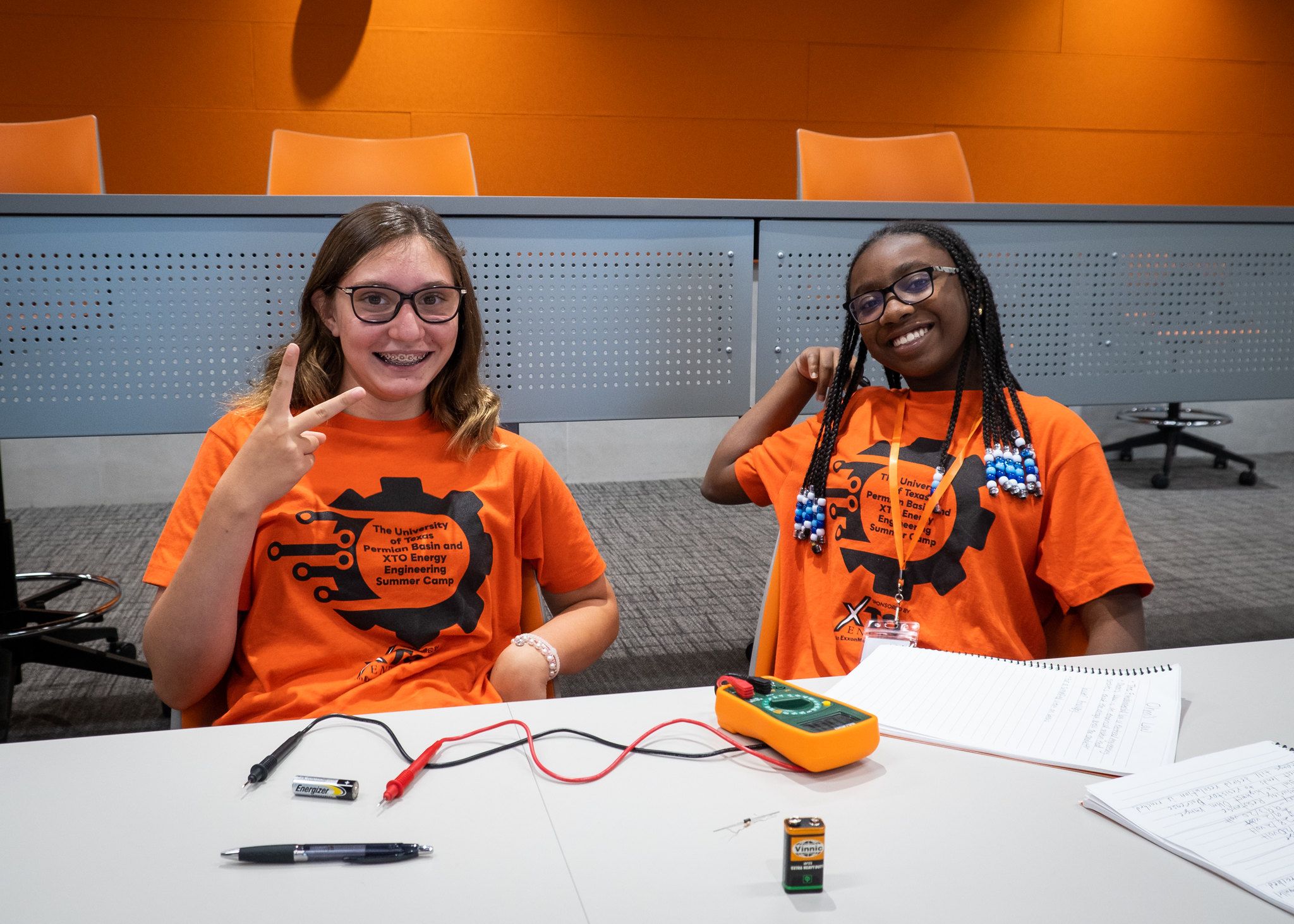 Two junior high students in their UTPB engineering camp shirts posing for a picture