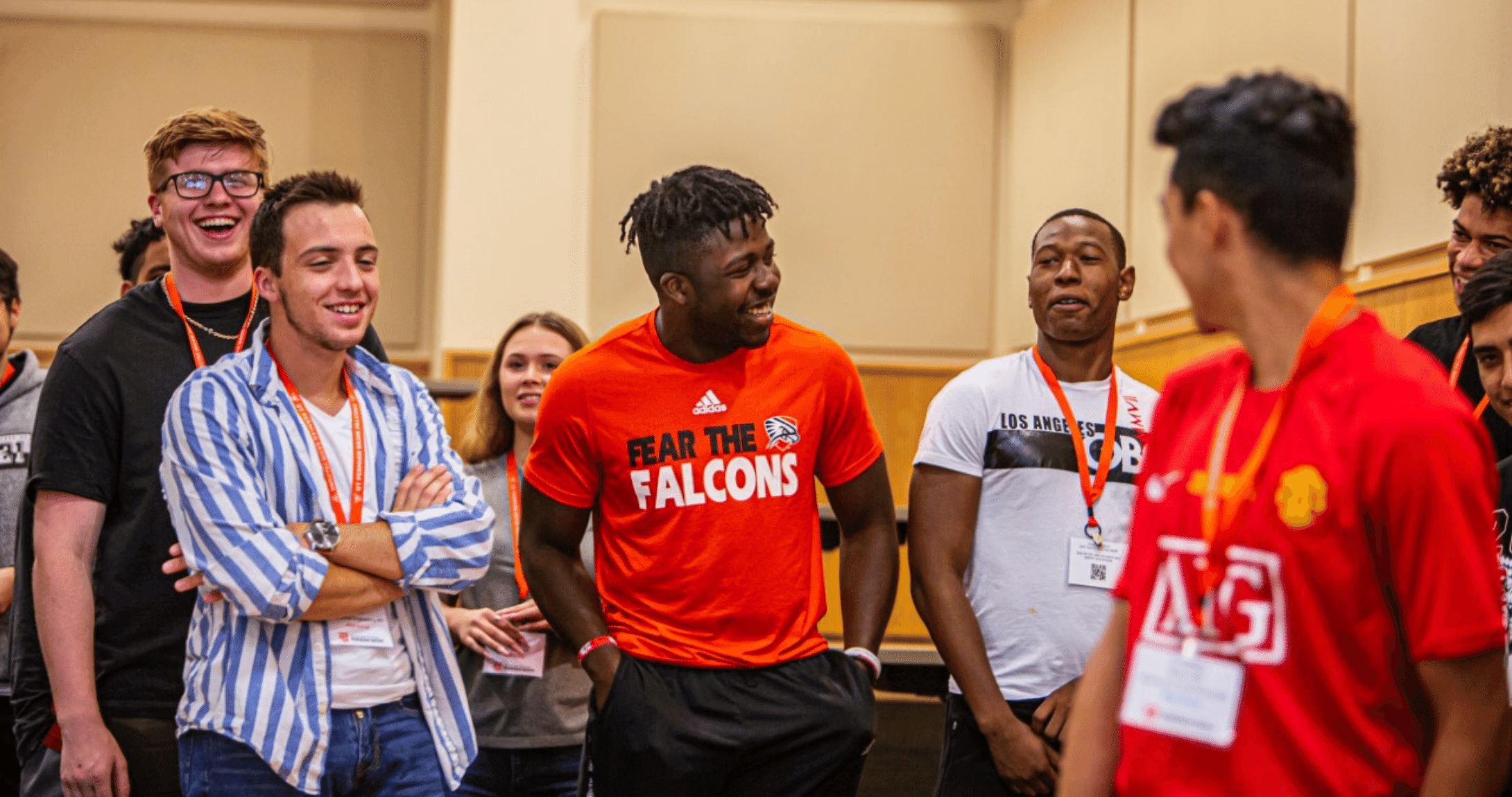 students standing in a line laughing