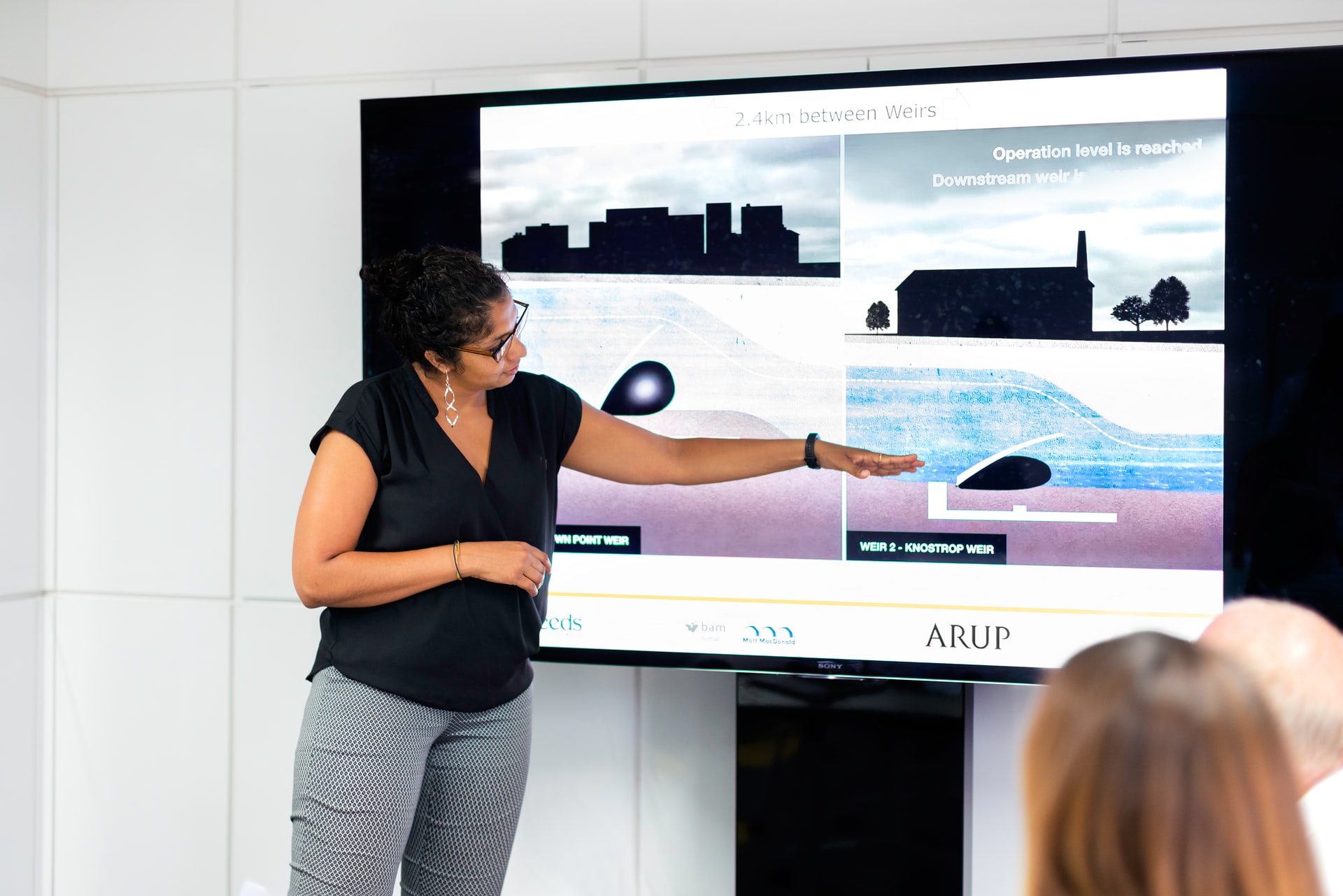 Lady giving a presentation to a group of people