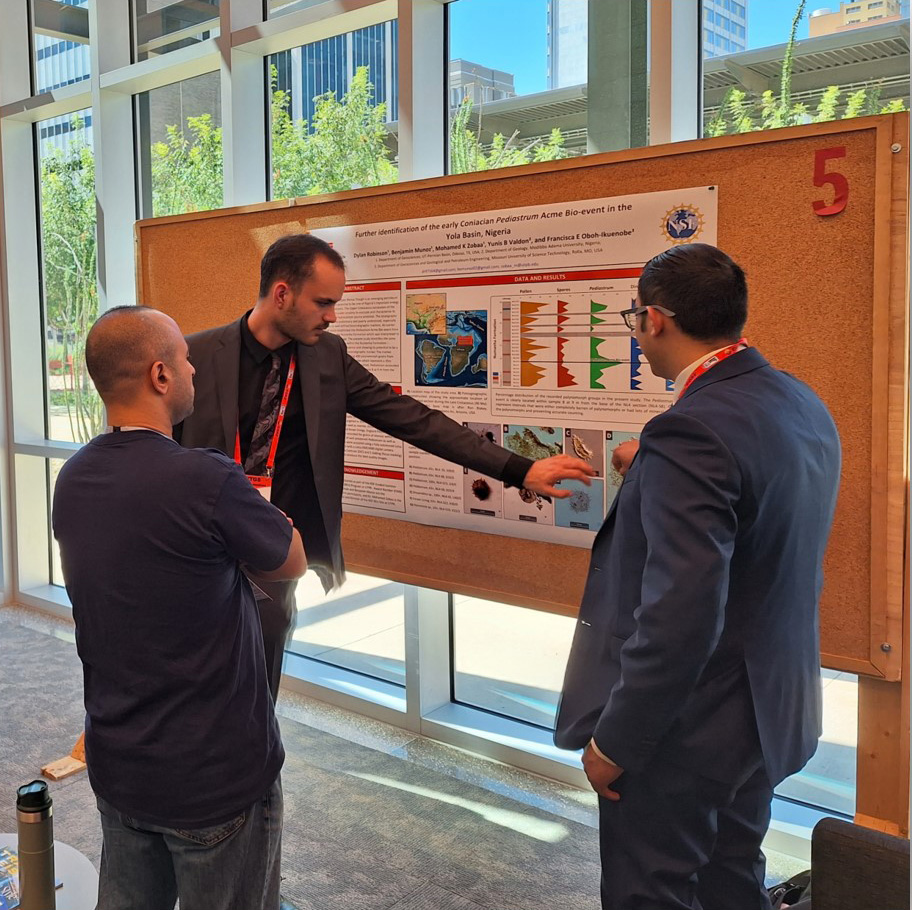 researchers around a cork board working